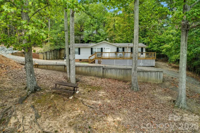 a view of a house with a yard from a lake view