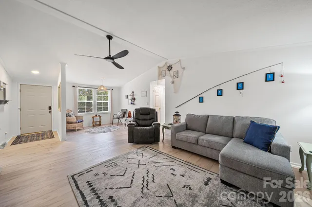 a living room with furniture ceiling fan and a rug