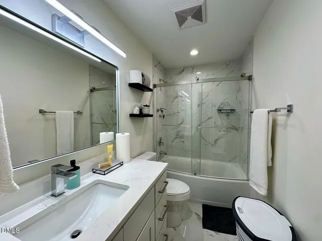 a bathroom with a sink toilet tub and shower