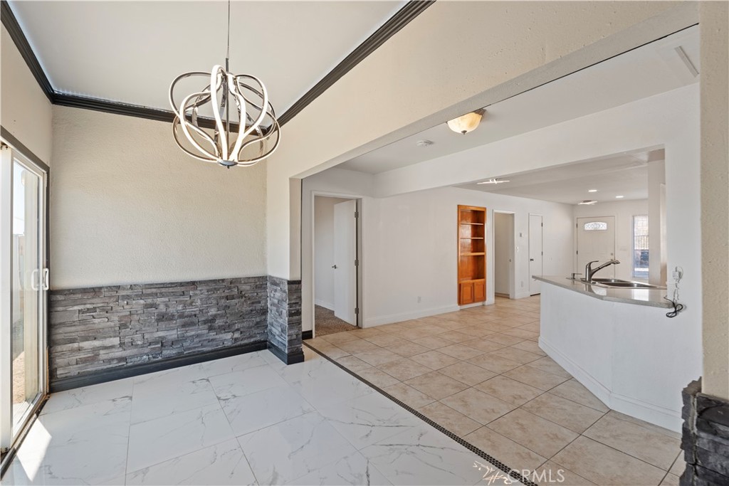 23859 S Road Apple Valley, CA 92307 - Photo 12 of 45 a view of a hallway with a chandelier