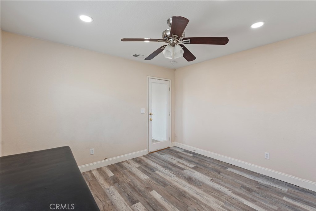 23859 S Road Apple Valley, CA 92307 - Photo 14 of 45 an empty room with a window and a ceiling fan