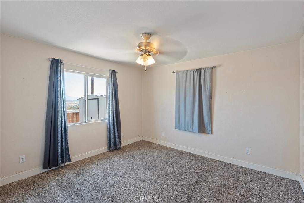 23859 S Road Apple Valley, CA 92307 - Photo 16 of 45 an empty room with windows and fan