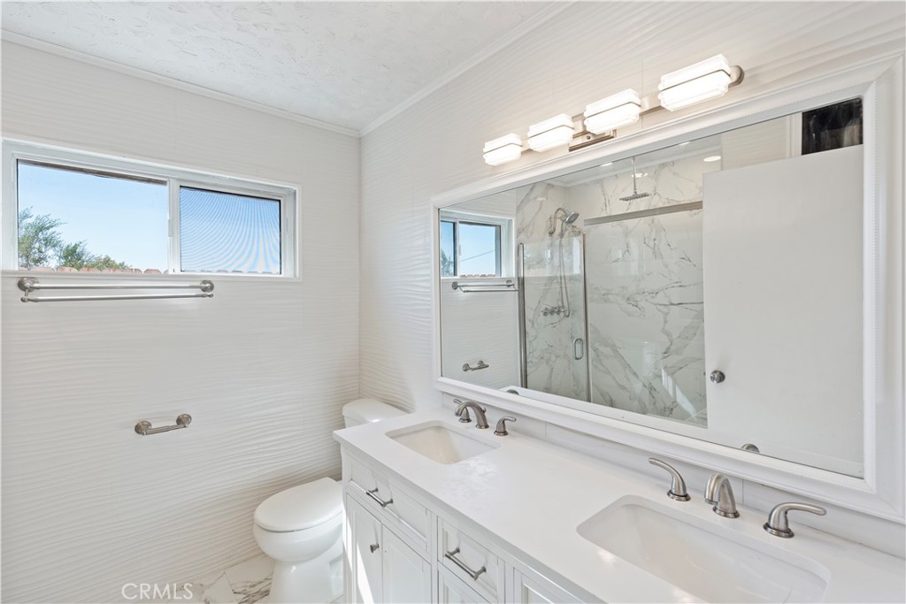 23859 S Road Apple Valley, CA 92307 - Photo 20 of 45 a bathroom with a double vanity sink mirror and toilet
