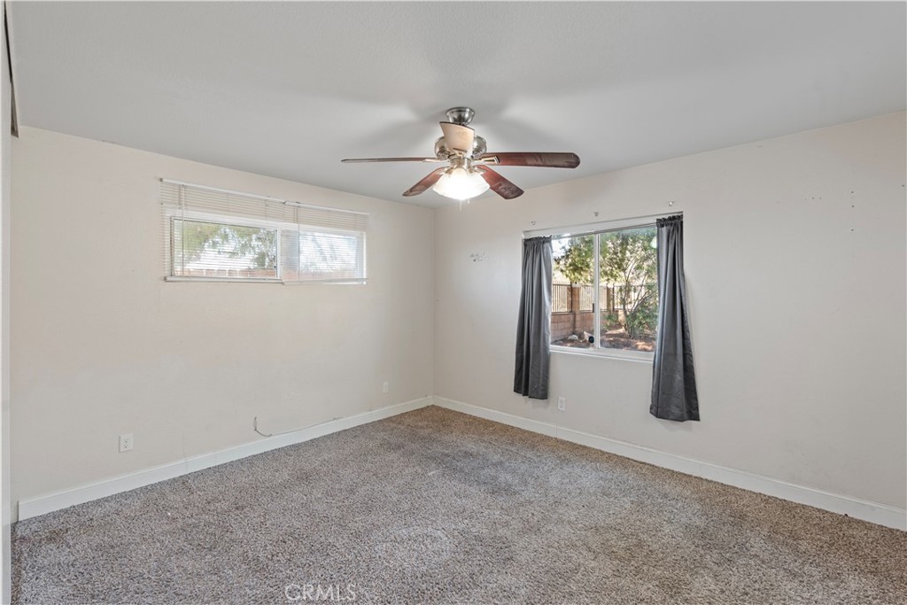 23859 S Road Apple Valley, CA 92307 - Photo 22 of 45 an empty room with windows and fan