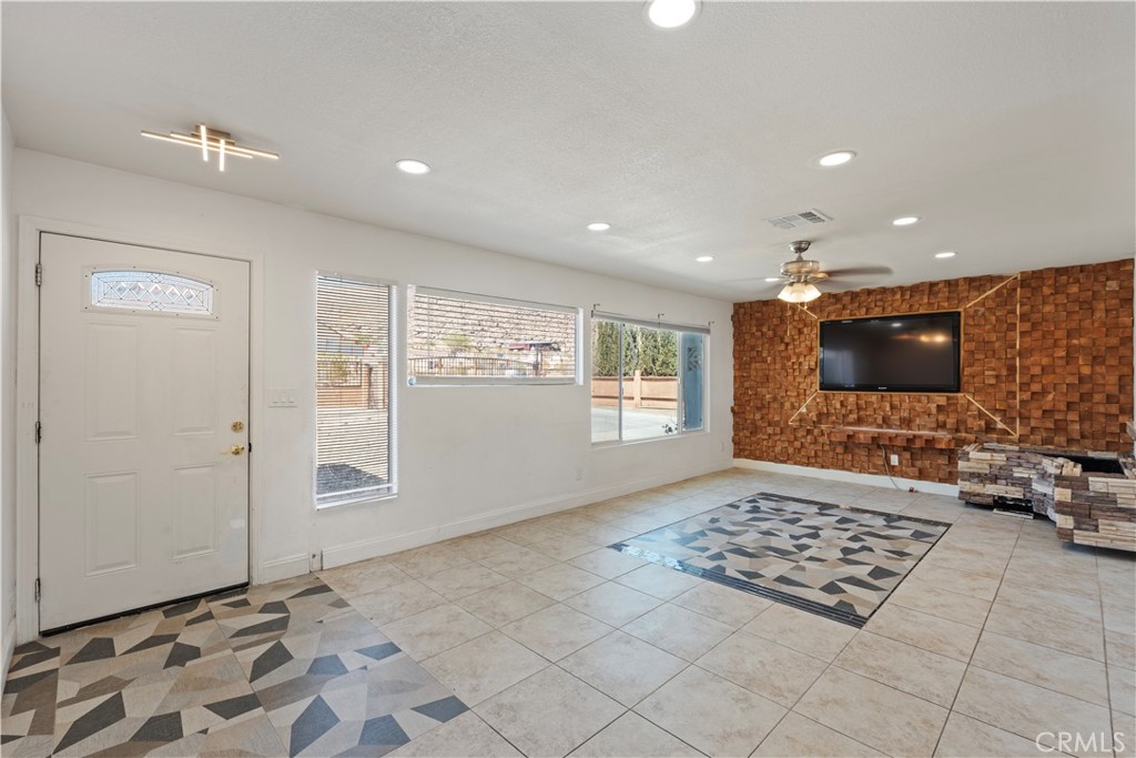 23859 S Road Apple Valley, CA 92307 - Photo 5 of 45 a living room with a flat screen tv and a rug