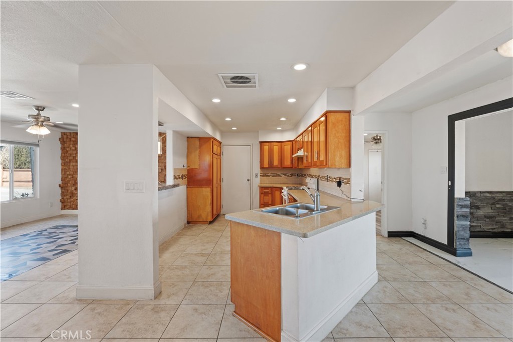 23859 S Road Apple Valley, CA 92307 - Photo 7 of 45 a kitchen with stainless steel appliances kitchen island granite countertop a refrigerator and a sink