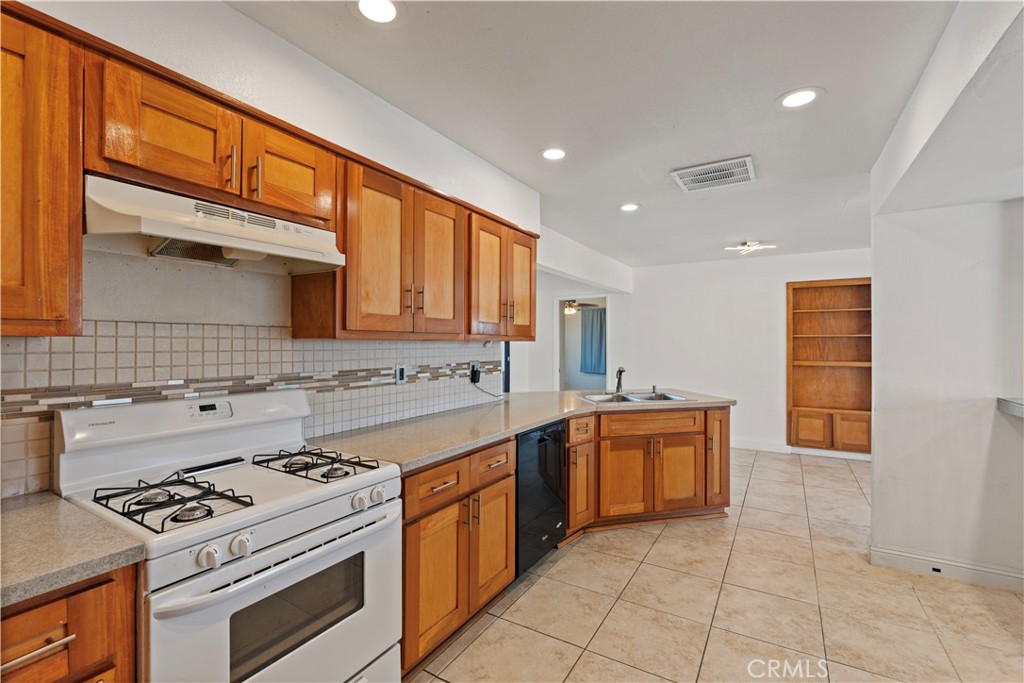 23859 S Road Apple Valley, CA 92307 - Photo 9 of 45 a kitchen with stainless steel appliances granite countertop a stove and a sink