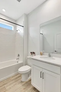 a bathroom with a sink a toilet and a bathtub