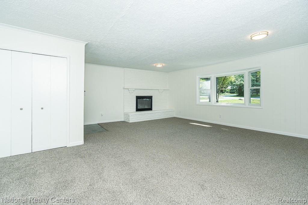 144 West Maryknoll Road Rochester, MI 48309 - Photo 24 of 38 Spacious recreational room with neutral carpet flooring, recessed ceiling lighting, and abundant natural light from multiple windows