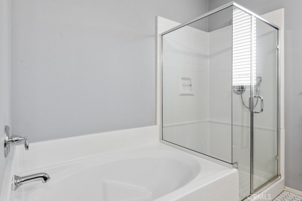 29463 Bouris Drive Menifee, CA 92584 - Photo 10 of 26 a bathroom with a bathtub and a shower
