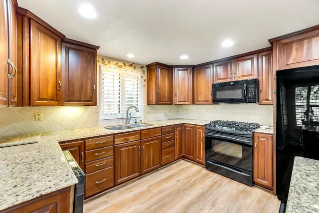 a kitchen with wooden cabinets and a sink