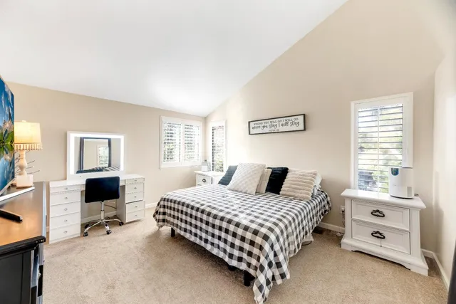 a bedroom with a bed and a television