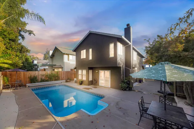 swimming pool view with a seating space