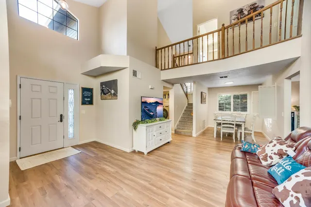 a living room with furniture and a wooden floor