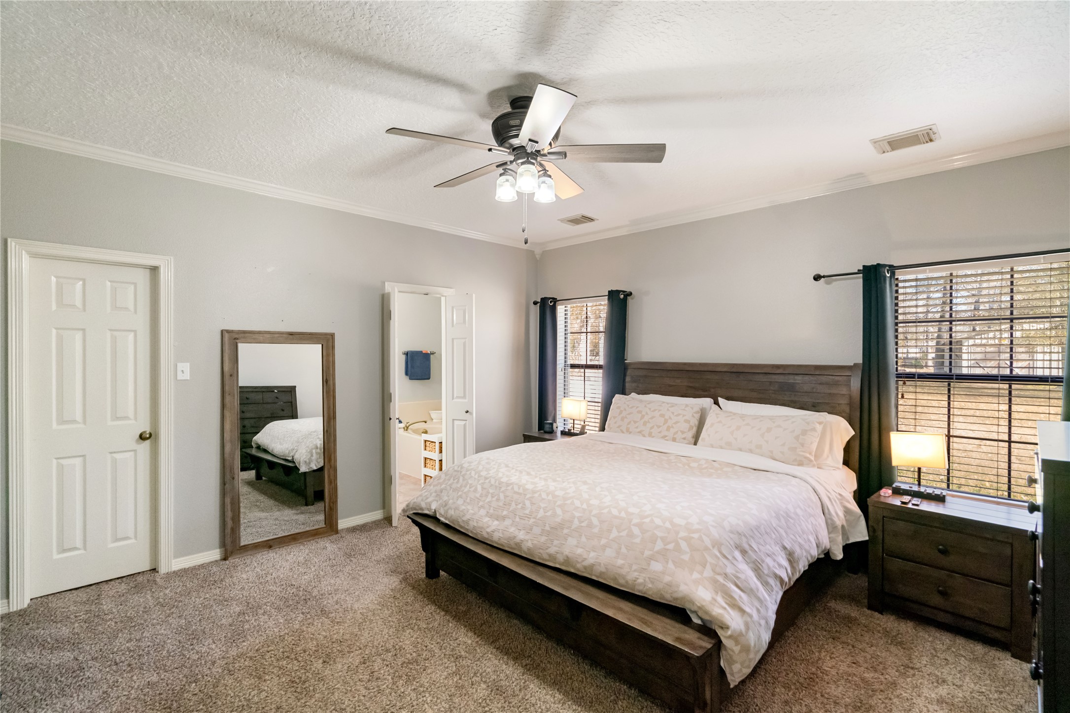 28911 Commons Oaks Drive Huffman, TX 77336 - Photo 13 of 26 a bedroom with a bed and a window