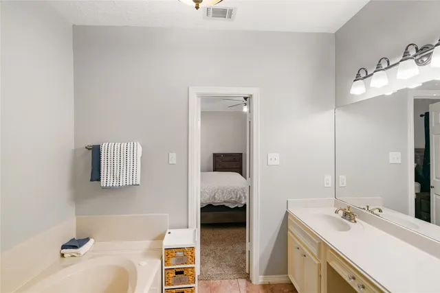 a en suite bathroom with a sink and mirror