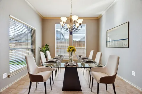 a view of a dining room with furniture wooden floor and chandelier