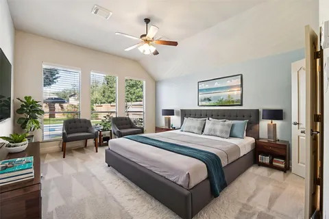 a bedroom with a large bed and a chandelier