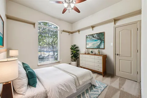 a bedroom with a large bed and a window