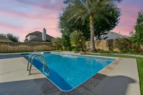 a view of swimming pool with a yard