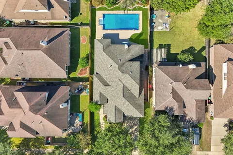 an aerial view of multiple houses with yard