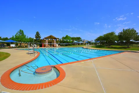 a view of a swimming pool with an outdoor space and seating area