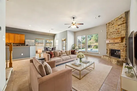 a living room with furniture fireplace and a large window