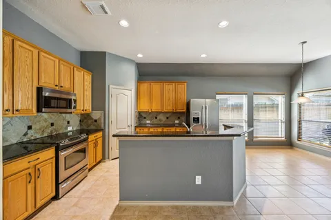 a kitchen with stainless steel appliances a stove sink and microwave