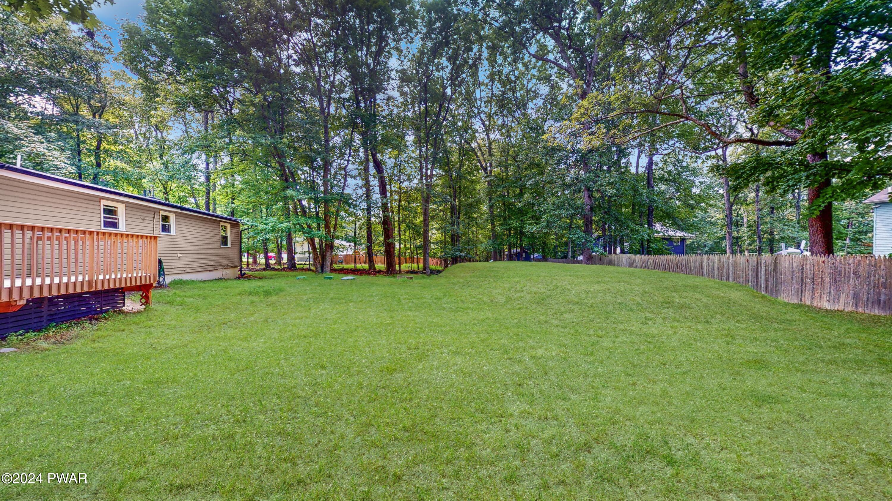 107 Hickory Road Milford, PA 18337 - Photo 15 of 39 a view of a backyard with a garden and entertaining space