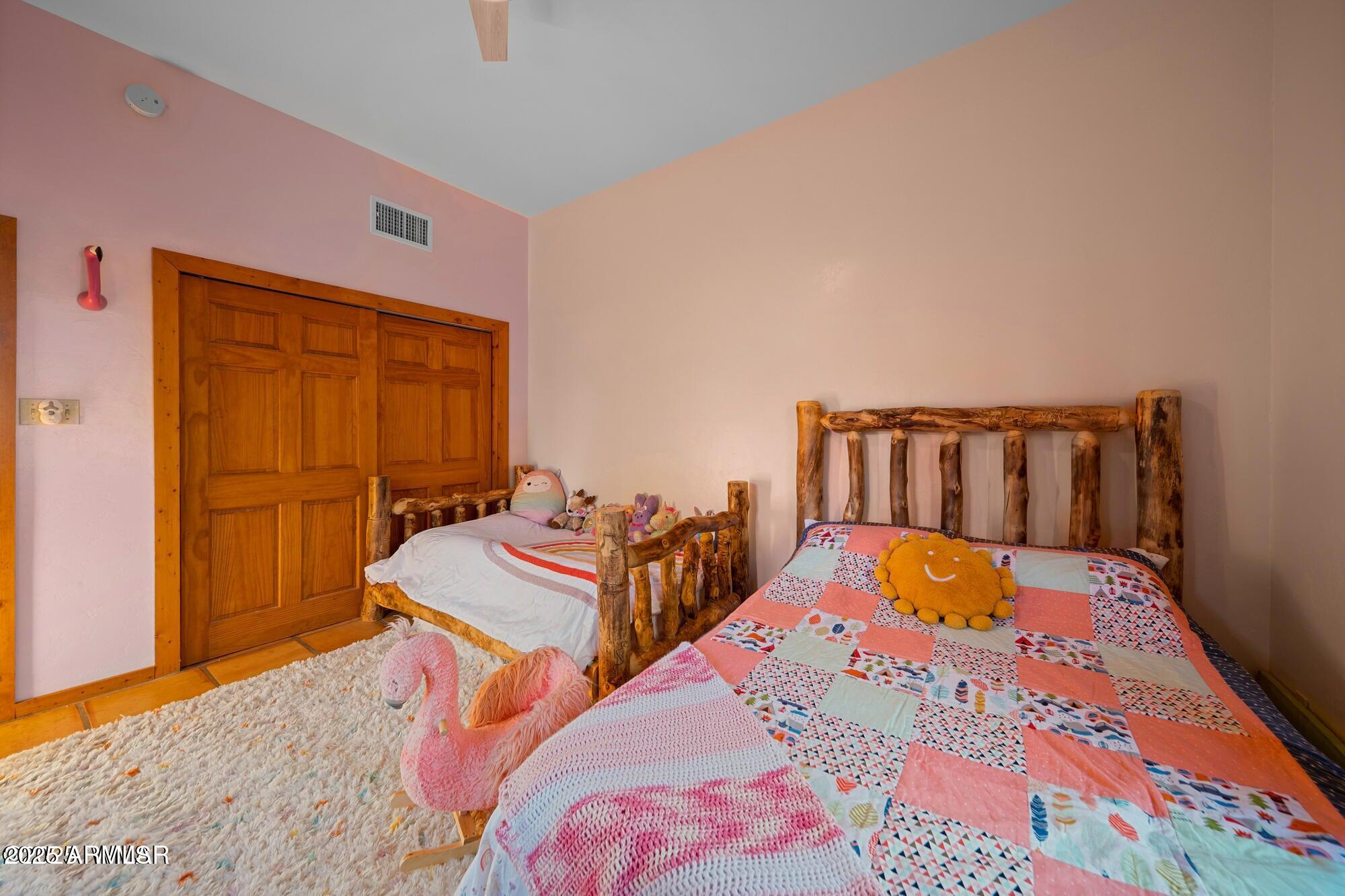 1923 Creekside Circle Show Low, AZ 85901 - Photo 40 of 71 a bedroom with two beds and a dresser