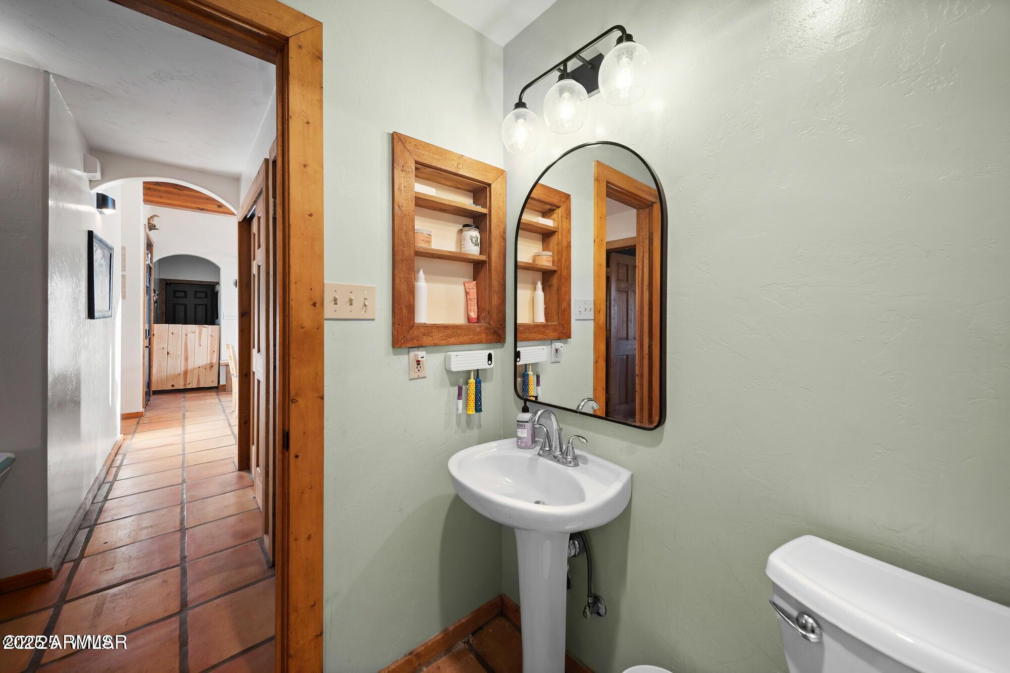 1923 Creekside Circle Show Low, AZ 85901 - Photo 43 of 71 a bathroom with a sink and a mirror