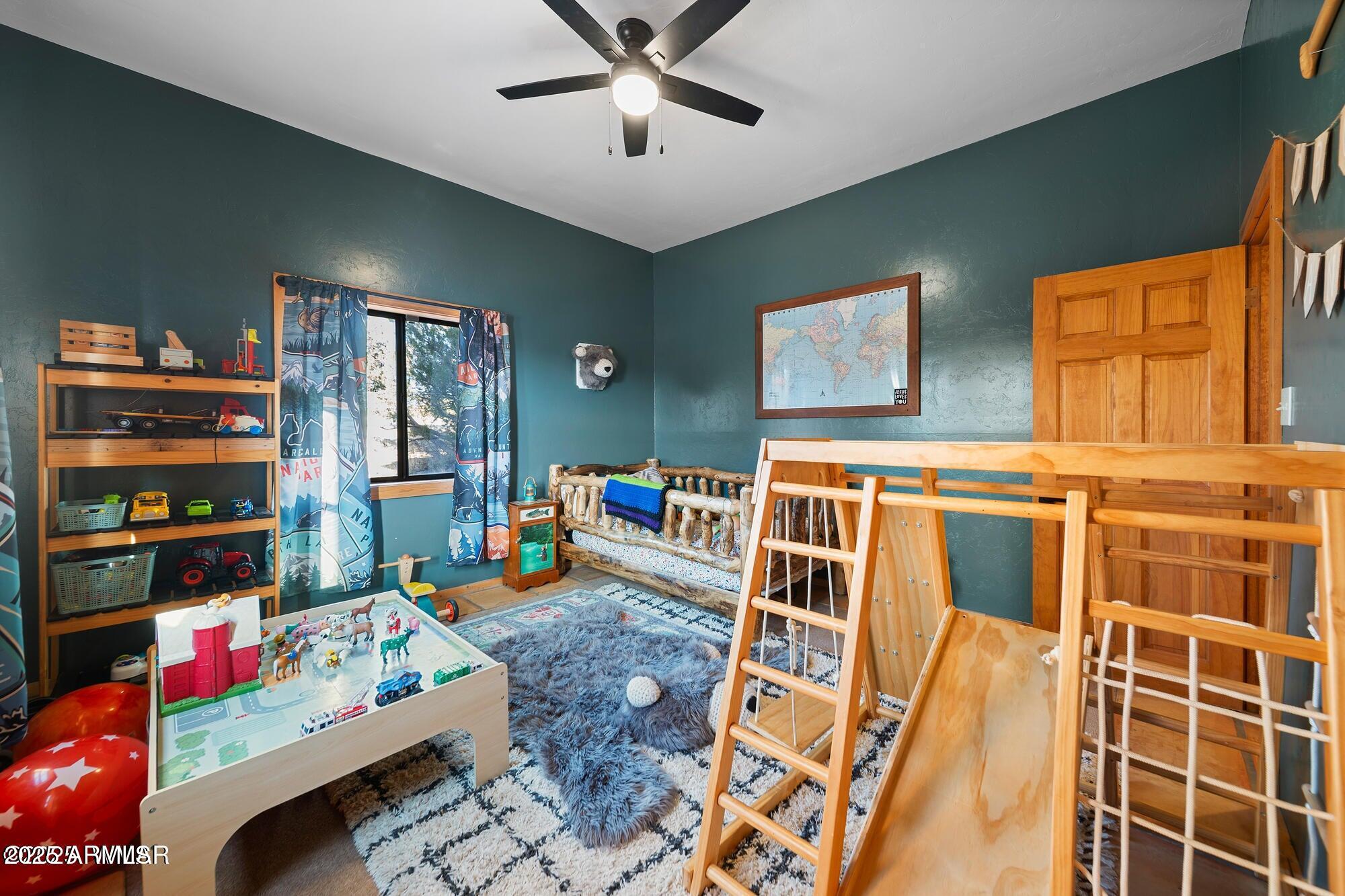 1923 Creekside Circle Show Low, AZ 85901 - Photo 45 of 71 a living room with lots of furniture and baby bed