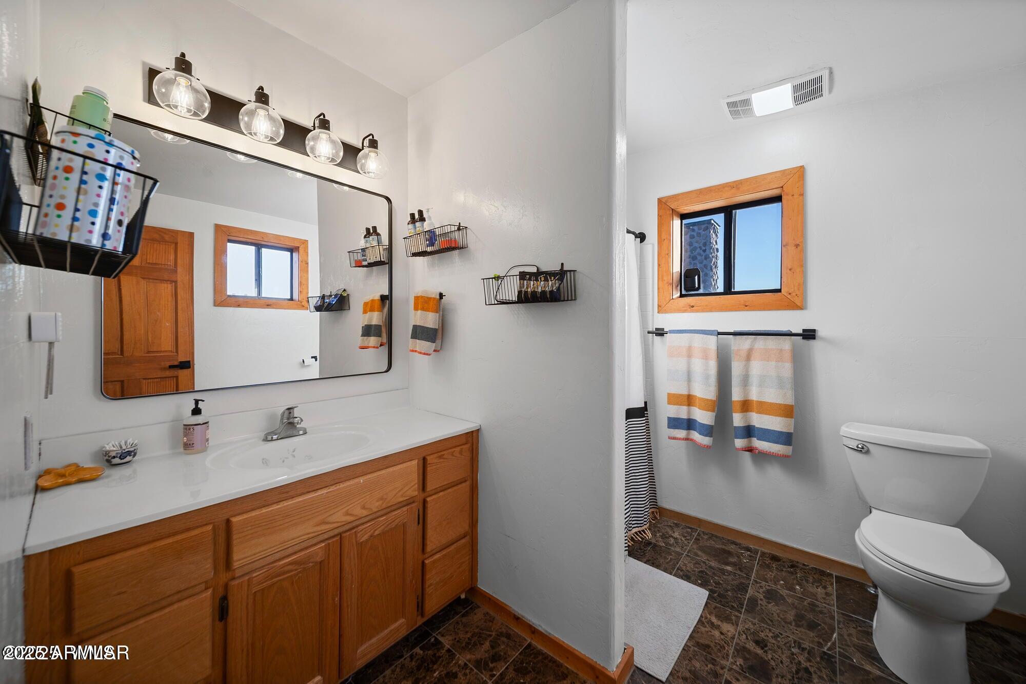 1923 Creekside Circle Show Low, AZ 85901 - Photo 49 of 71 a bathroom with a toilet sink and mirror