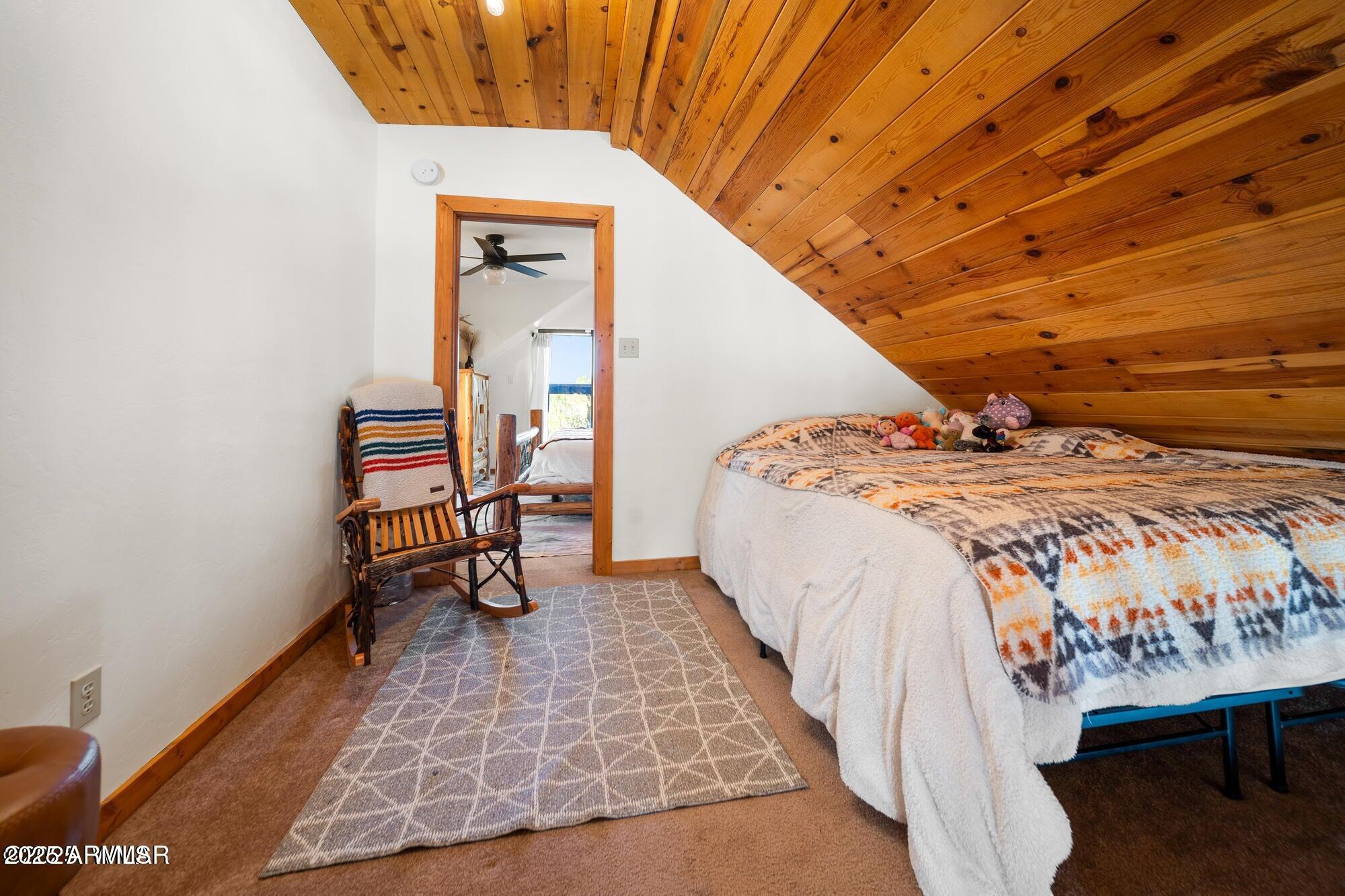 1923 Creekside Circle Show Low, AZ 85901 - Photo 55 of 71 a bed sitting in a bedroom next to a window