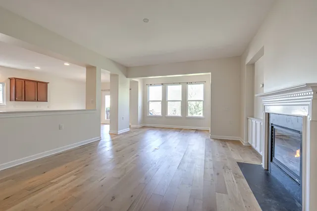 a view of a room with wooden floor and large window