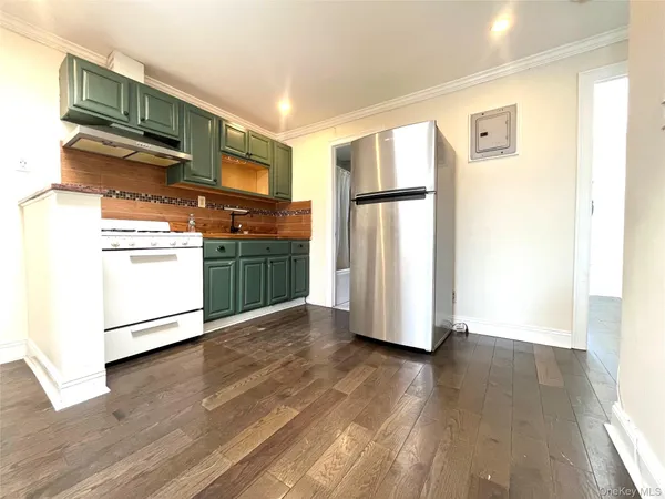 a kitchen with stainless steel appliances a refrigerator and a stove top oven