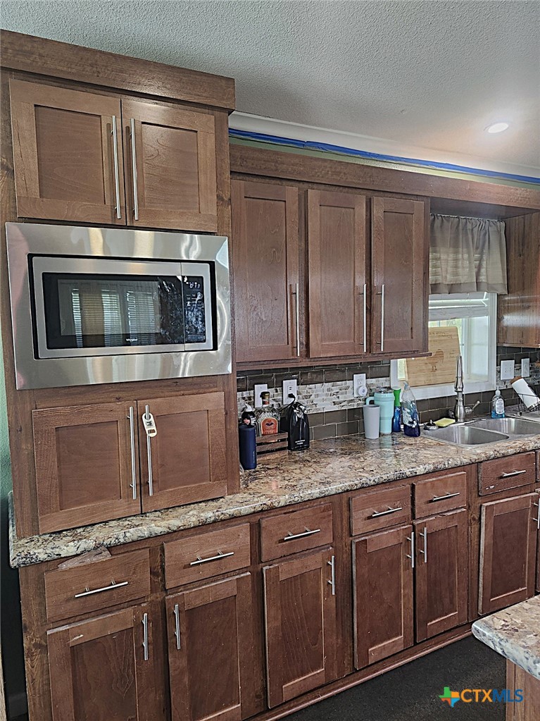 1845 Royal Road Port Lavaca, TX 77979 - Photo 4 of 22 a kitchen with stainless steel appliances granite countertop a sink and cabinets