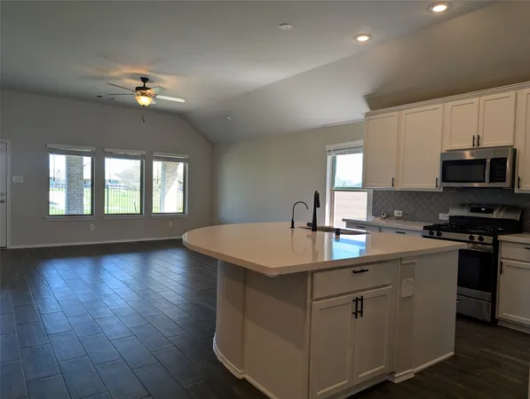 a kitchen with sink cabinets and chandelier