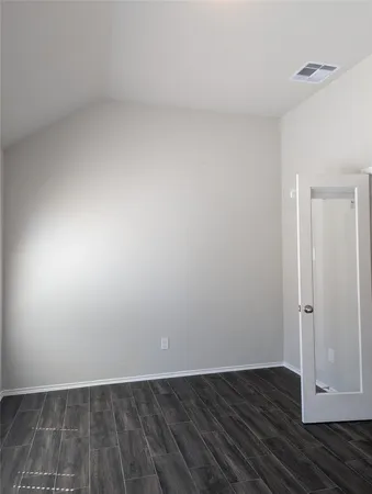 a view of an empty room and wooden floor