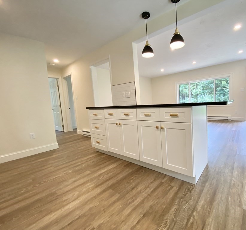 5 Wellesley Avenue Worcester, MA 01605 - Photo 12 of 31 a view of a kitchen with a sink and dishwasher with wooden floor