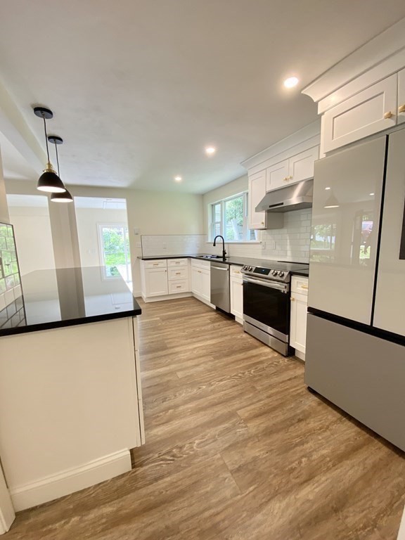 5 Wellesley Avenue Worcester, MA 01605 - Photo 14 of 31 a large kitchen with stainless steel appliances granite countertop a stove a sink and a refrigerator