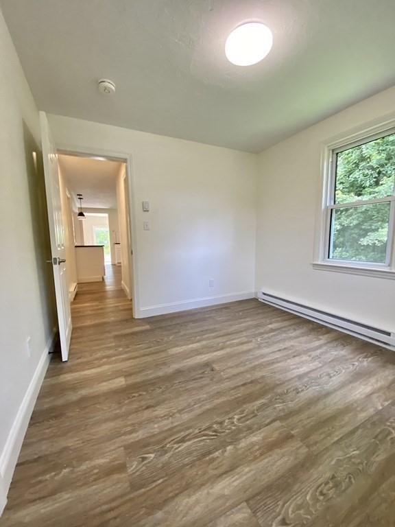 5 Wellesley Avenue Worcester, MA 01605 - Photo 19 of 31 an empty room with wooden floor and windows