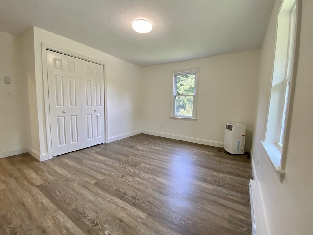 5 Wellesley Avenue Worcester, MA 01605 - Photo 21 of 31 a view of an empty room with wooden floor and a window