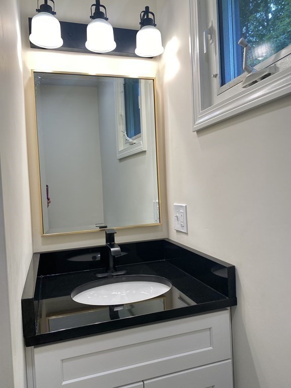 5 Wellesley Avenue Worcester, MA 01605 - Photo 23 of 31 a bathroom with a sink and a mirror