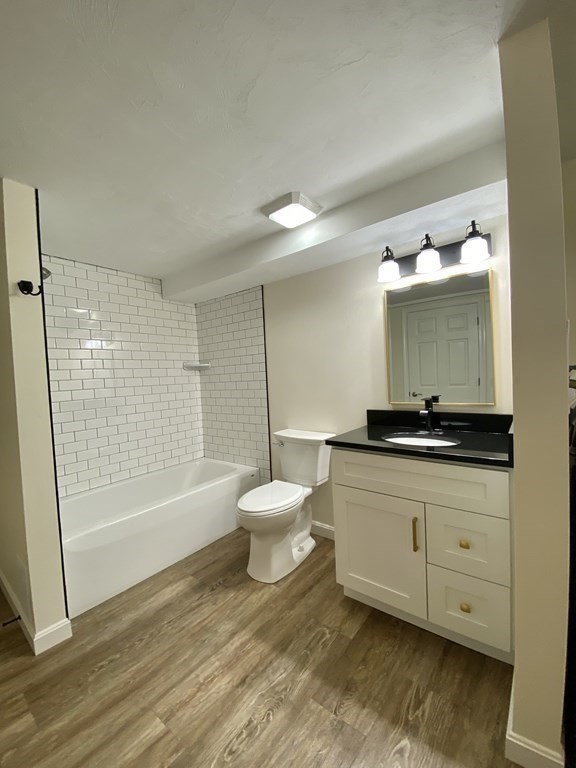 5 Wellesley Avenue Worcester, MA 01605 - Photo 27 of 31 a bathroom with a toilet sink and mirror