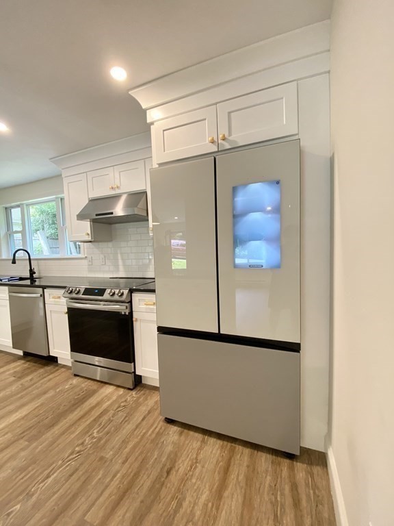 5 Wellesley Avenue Worcester, MA 01605 - Photo 10 of 31 a kitchen with stainless steel appliances granite countertop a refrigerator and a stove top oven