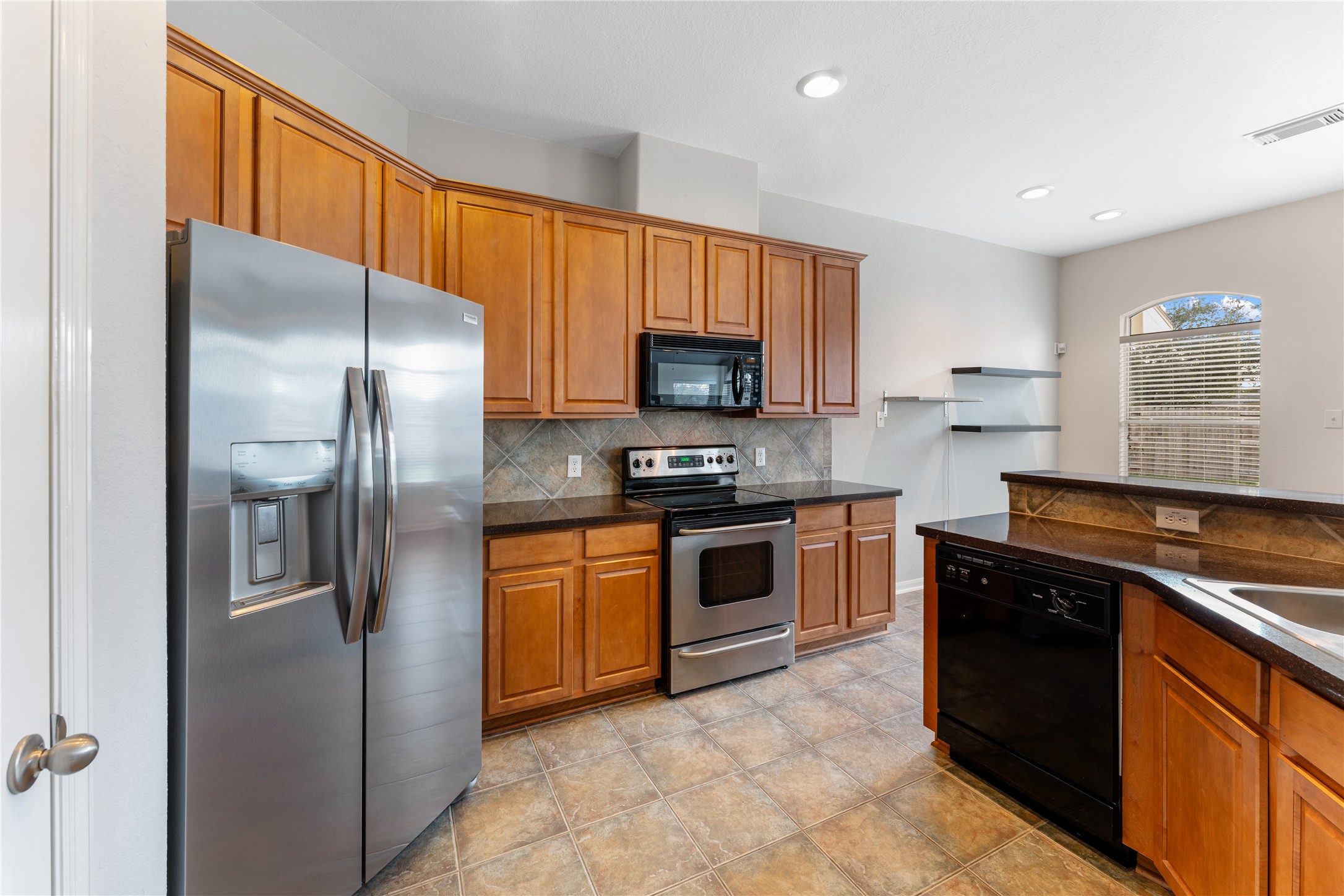 3214 Falcon Trail Drive Spring, TX 77373 - Photo 13 of 29 a kitchen with stainless steel appliances granite countertop a stove a refrigerator and a sink