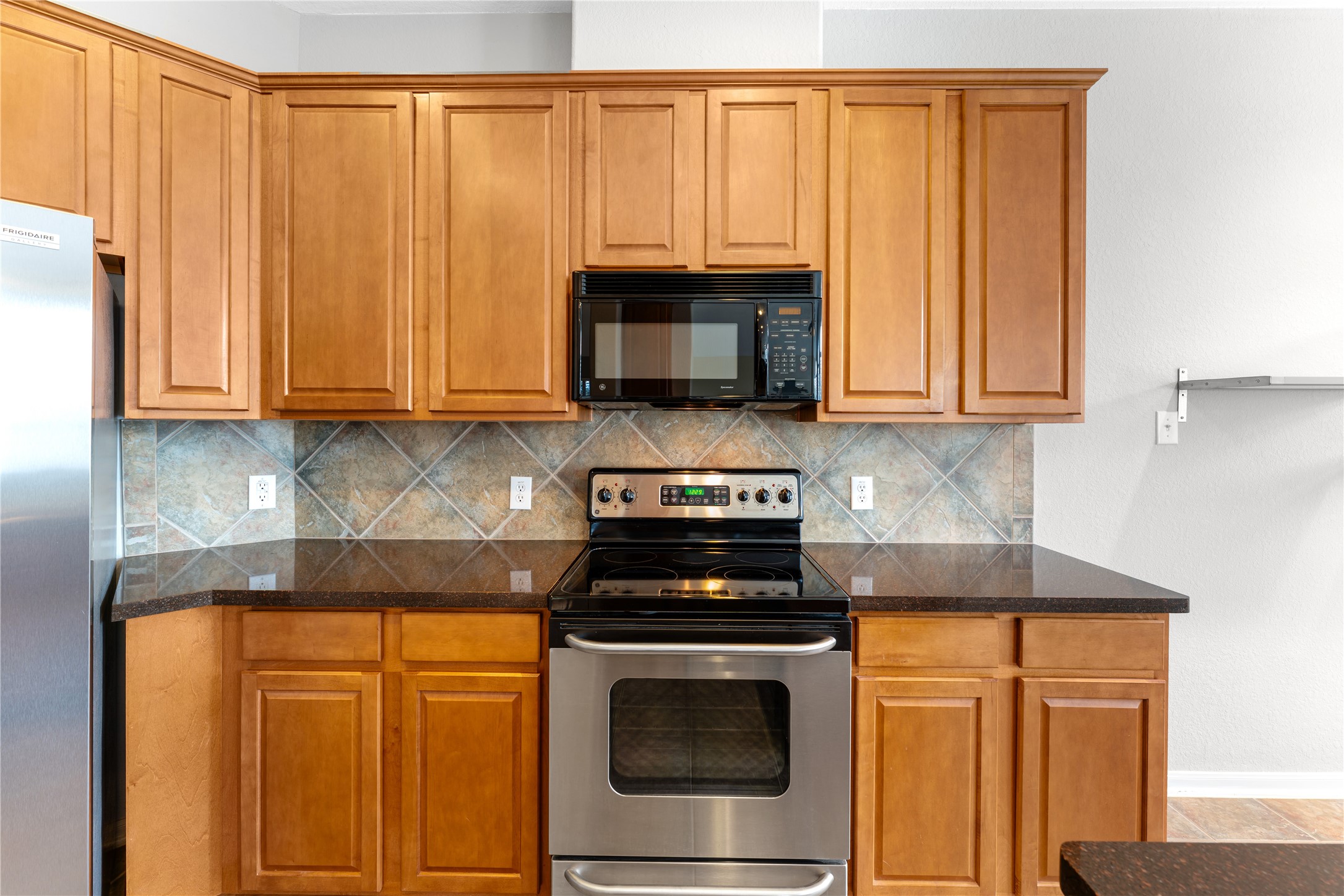 3214 Falcon Trail Drive Spring, TX 77373 - Photo 15 of 29 a kitchen with granite countertop wood cabinets and stainless steel appliances