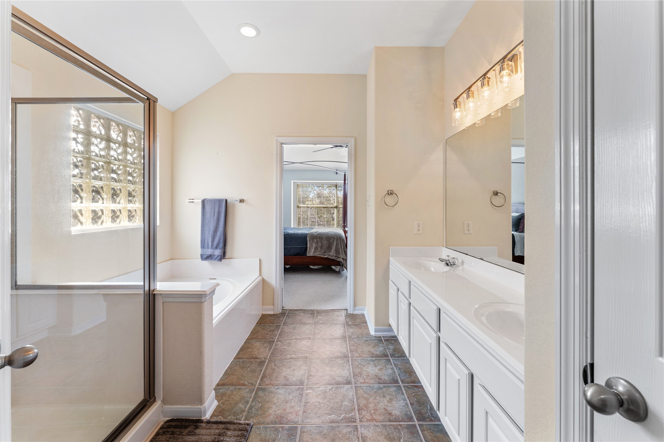 3214 Falcon Trail Drive Spring, TX 77373 - Photo 22 of 29 a bathroom with a double vanity sink a large mirror and a bathtub