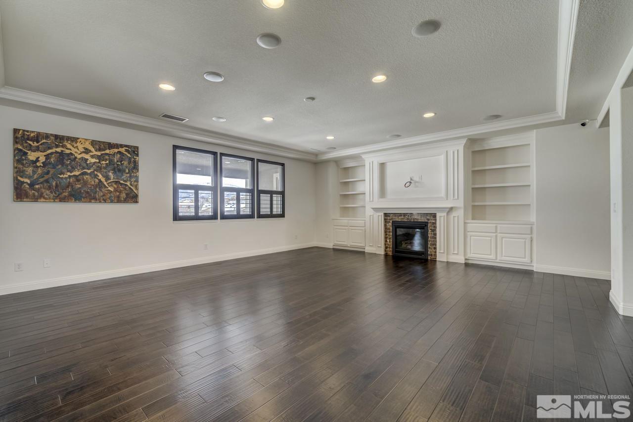 2105 Back Nine Trail Reno, NV 89523 - Photo 5 of 25 an empty room with wooden floor fireplace and windows